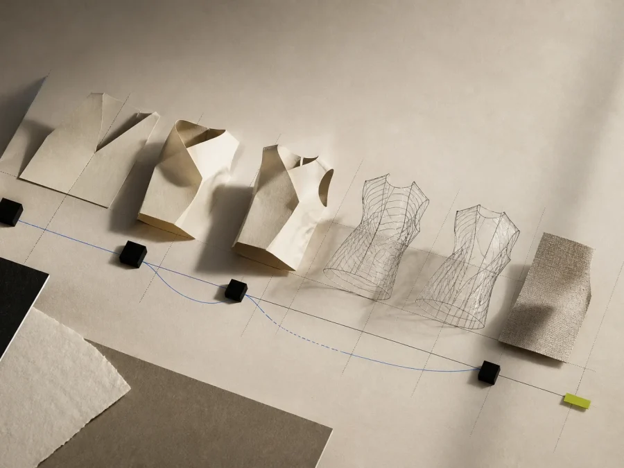 Sculptural paper garment volumes transition into a small neutral fabric sample across a strict cobalt development grid with an acid-lime validation tab.