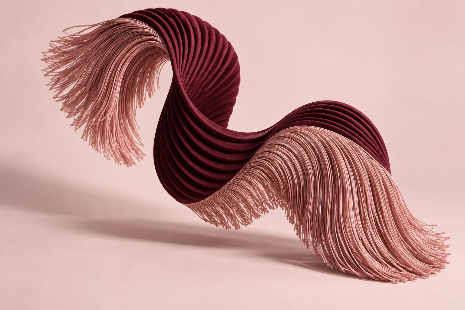 A burgundy pleated ribbon curves between two sweeps of pink fringe against a pale pink background.